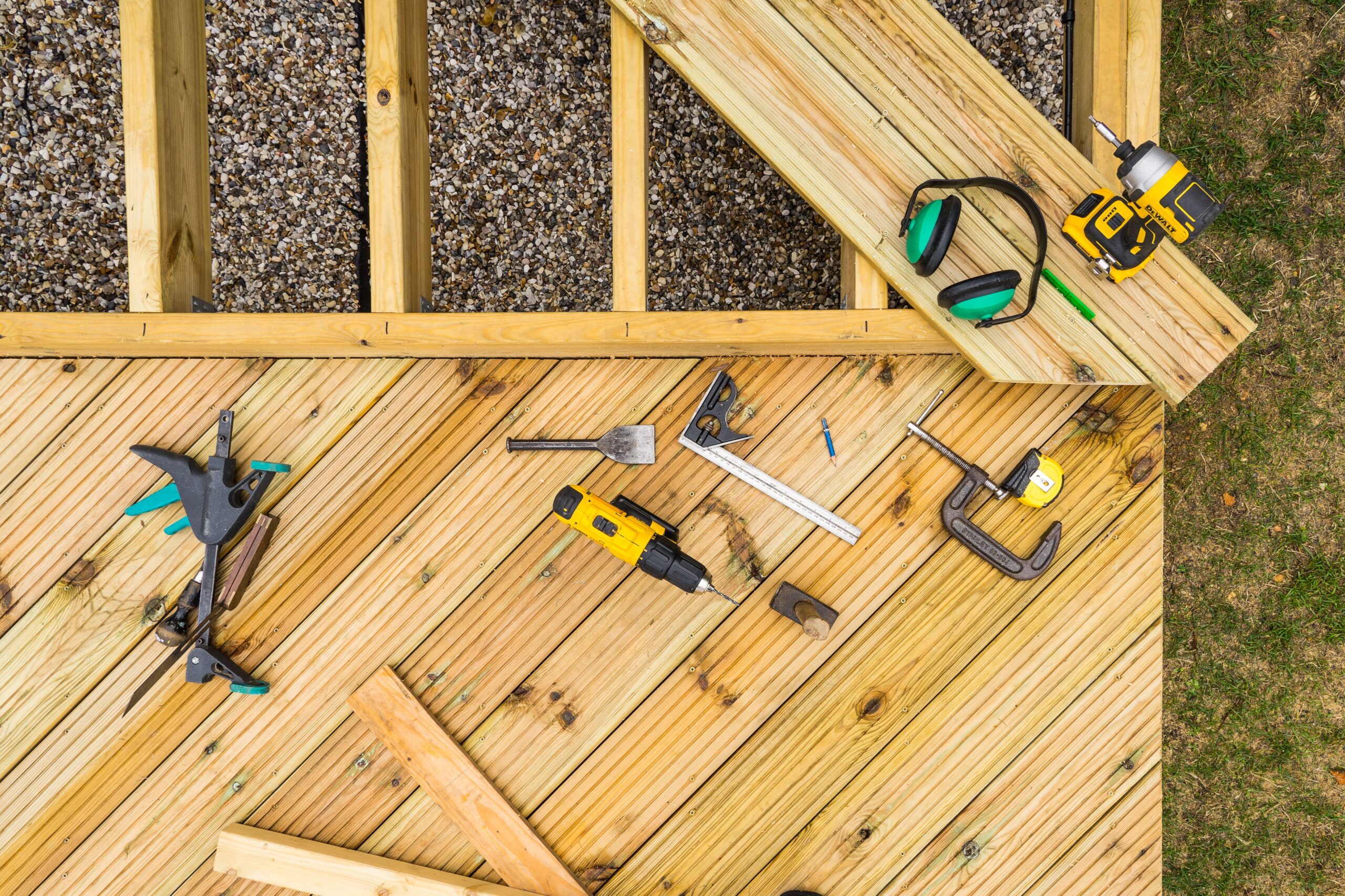 Image of tools, joists and planks, of a low level deck under construction